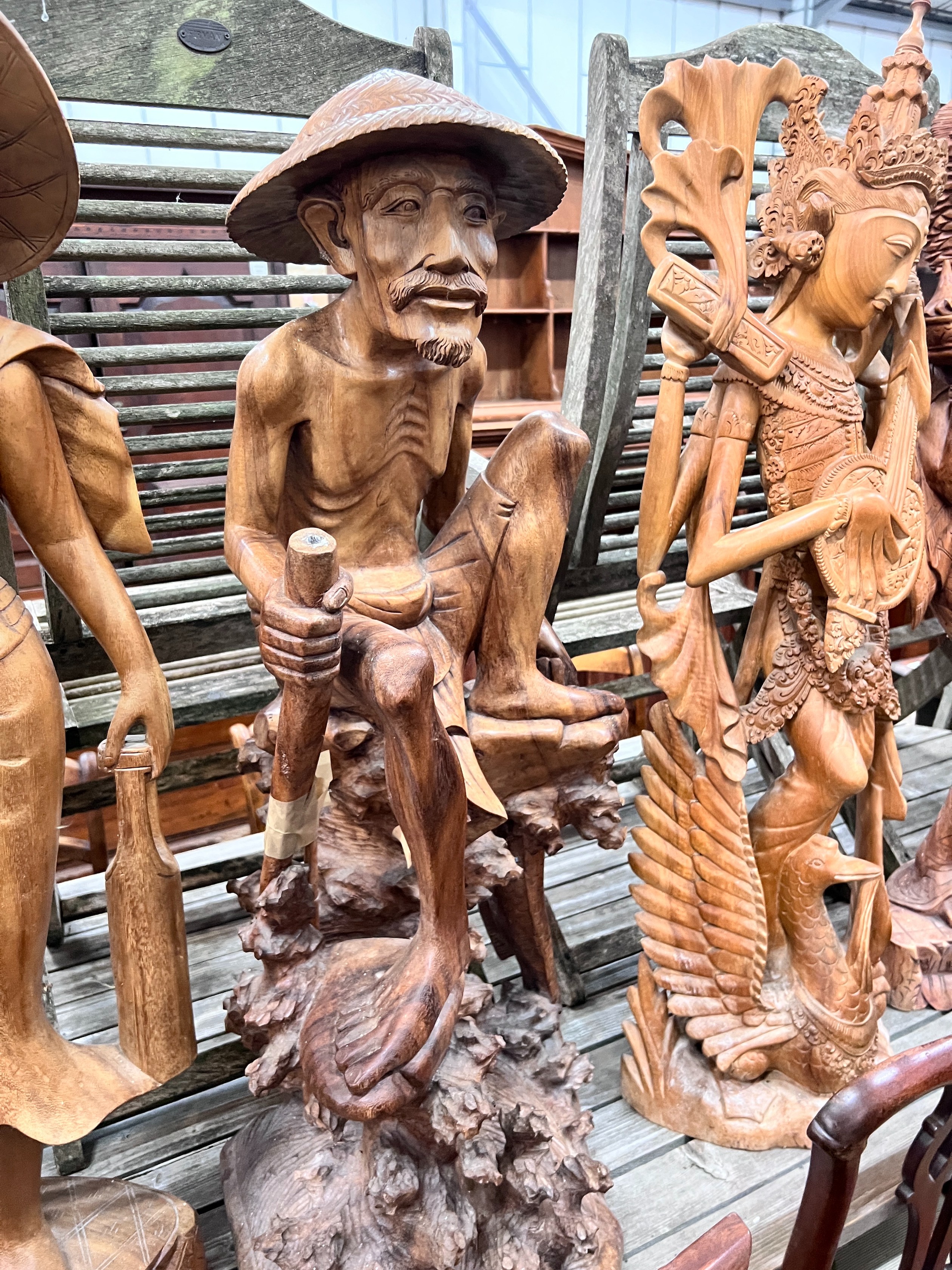 Six Balinese carved hardwood figures, largest height 104cm *Please note the sale commences at 9am.